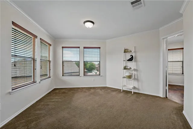 an empty room with windows and closet