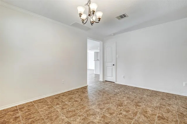 an empty room with windows and fireplace