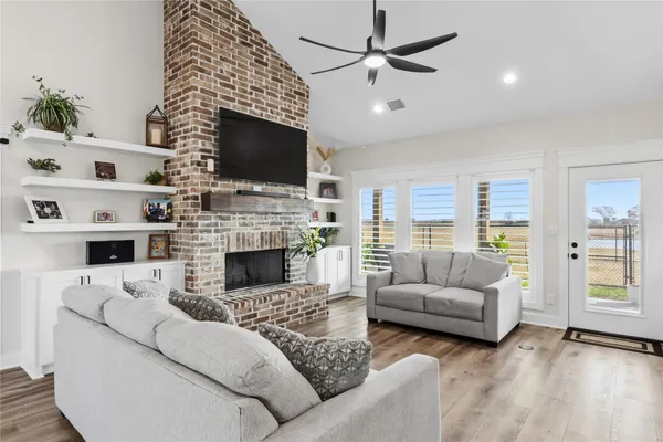 a living room with furniture fireplace and flat screen tv