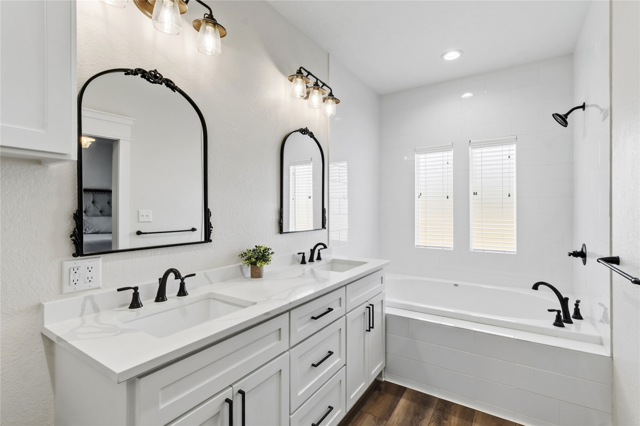 17637 Englin Road Winnie, TX 77665 - Photo 17 of 37 a bathroom with a double vanity sink and mirror with bathtub