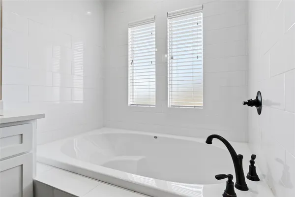 a bathroom with a bathtub and a window