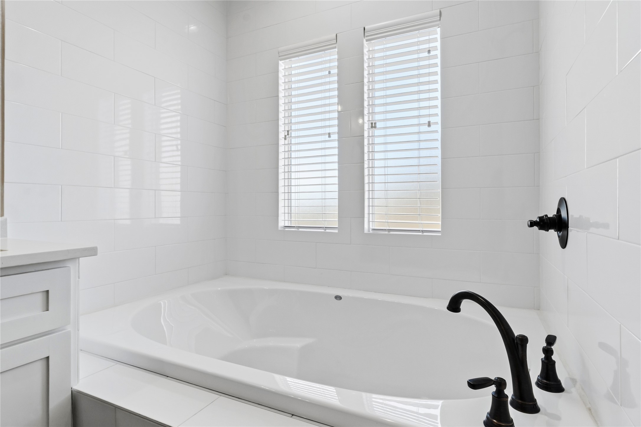 17637 Englin Road Winnie, TX 77665 - Photo 19 of 37 a bathroom with a bathtub and a window