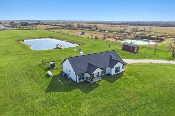 an aerial view of a house with outdoor space