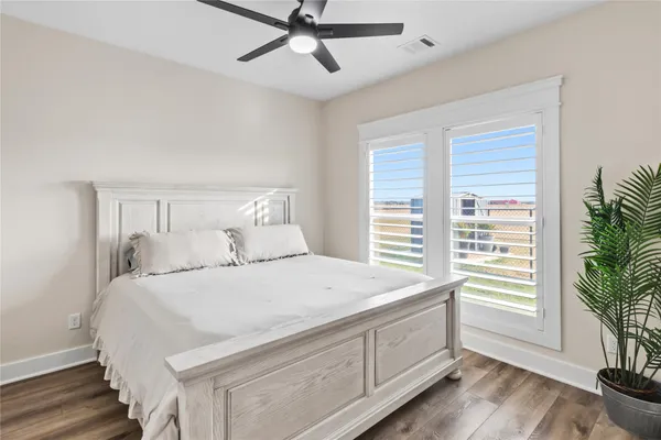 a bedroom with a bed and a potted plant