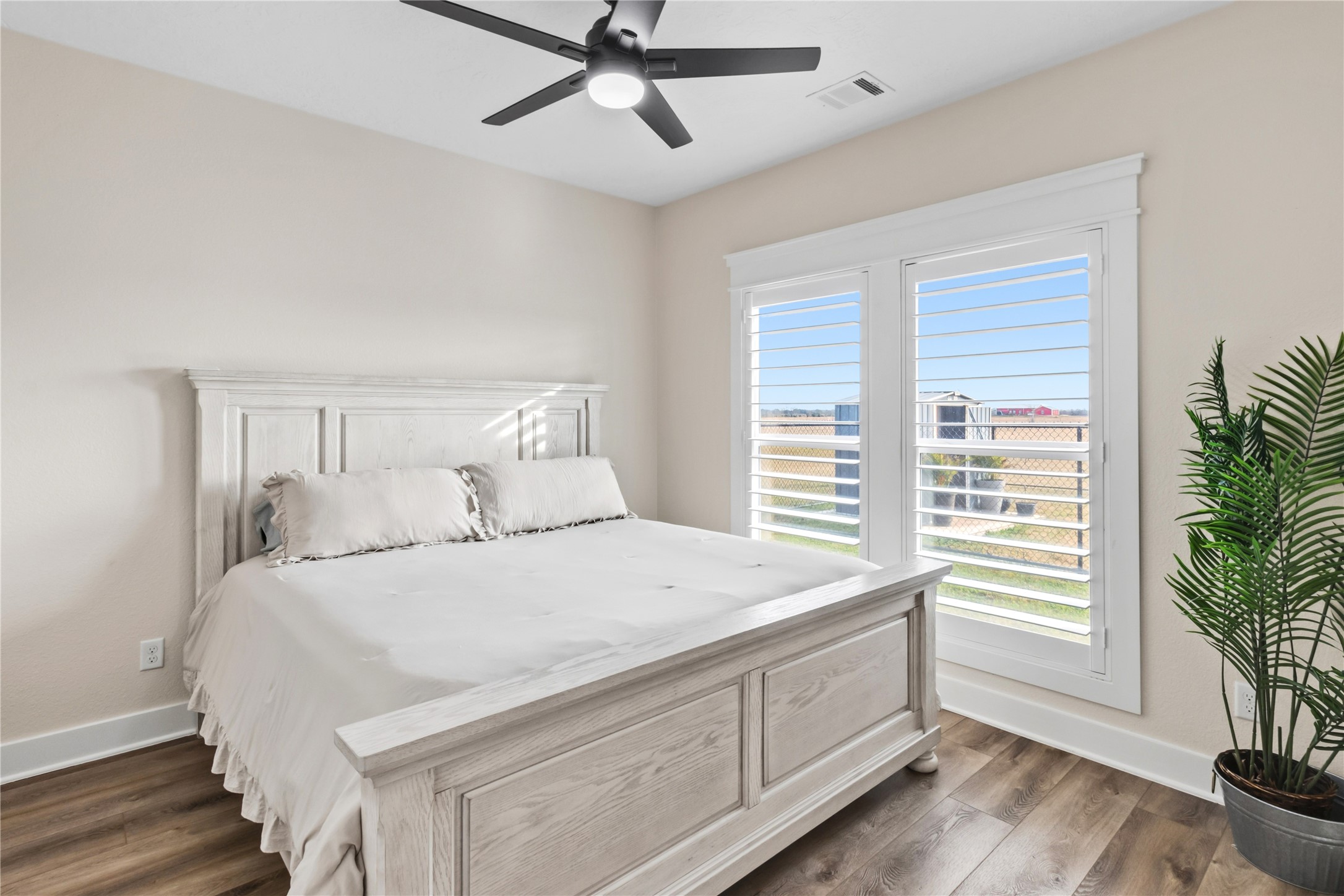 17637 Englin Road Winnie, TX 77665 - Photo 23 of 37 a bedroom with a bed and a potted plant