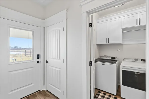 a view of a kitchen with closet and electronic appliances