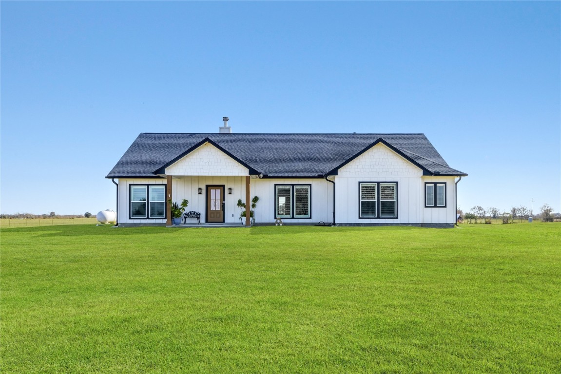 17637 Englin Road Winnie, TX 77665 - Photo 3 of 37 a front view of a house with garden