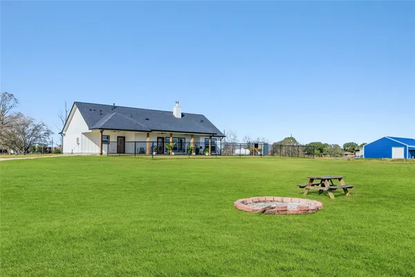 a big house with a big yard and large trees