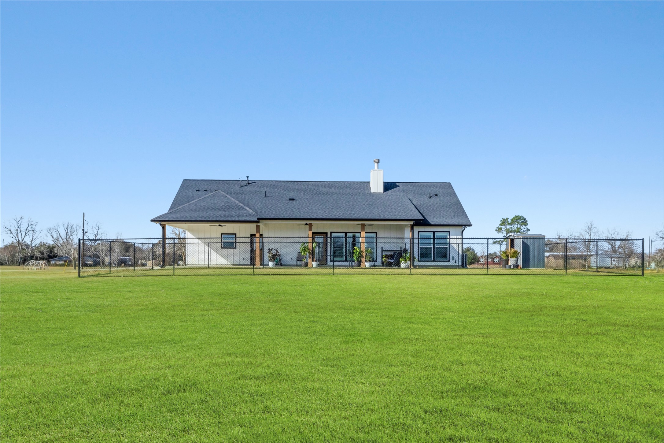 17637 Englin Road Winnie, TX 77665 - Photo 32 of 37 a big house with a big yard and large trees