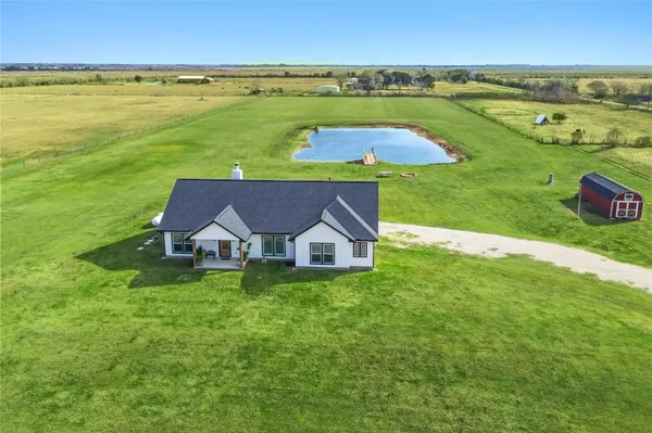 a view of a house with big yard and a large pool