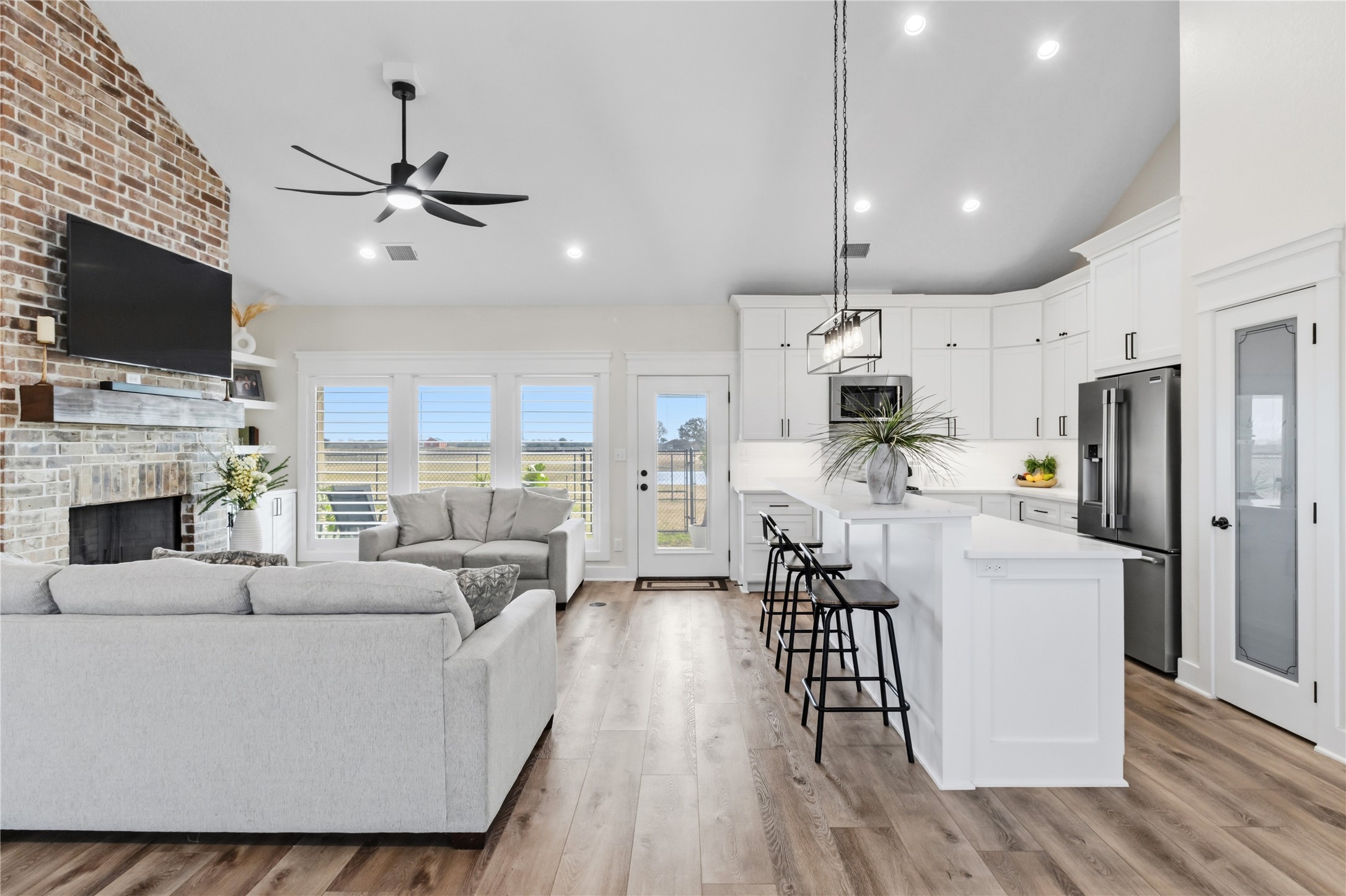 17637 Englin Road Winnie, TX 77665 - Photo 6 of 37 a living room with furniture a flat screen tv and a fireplace