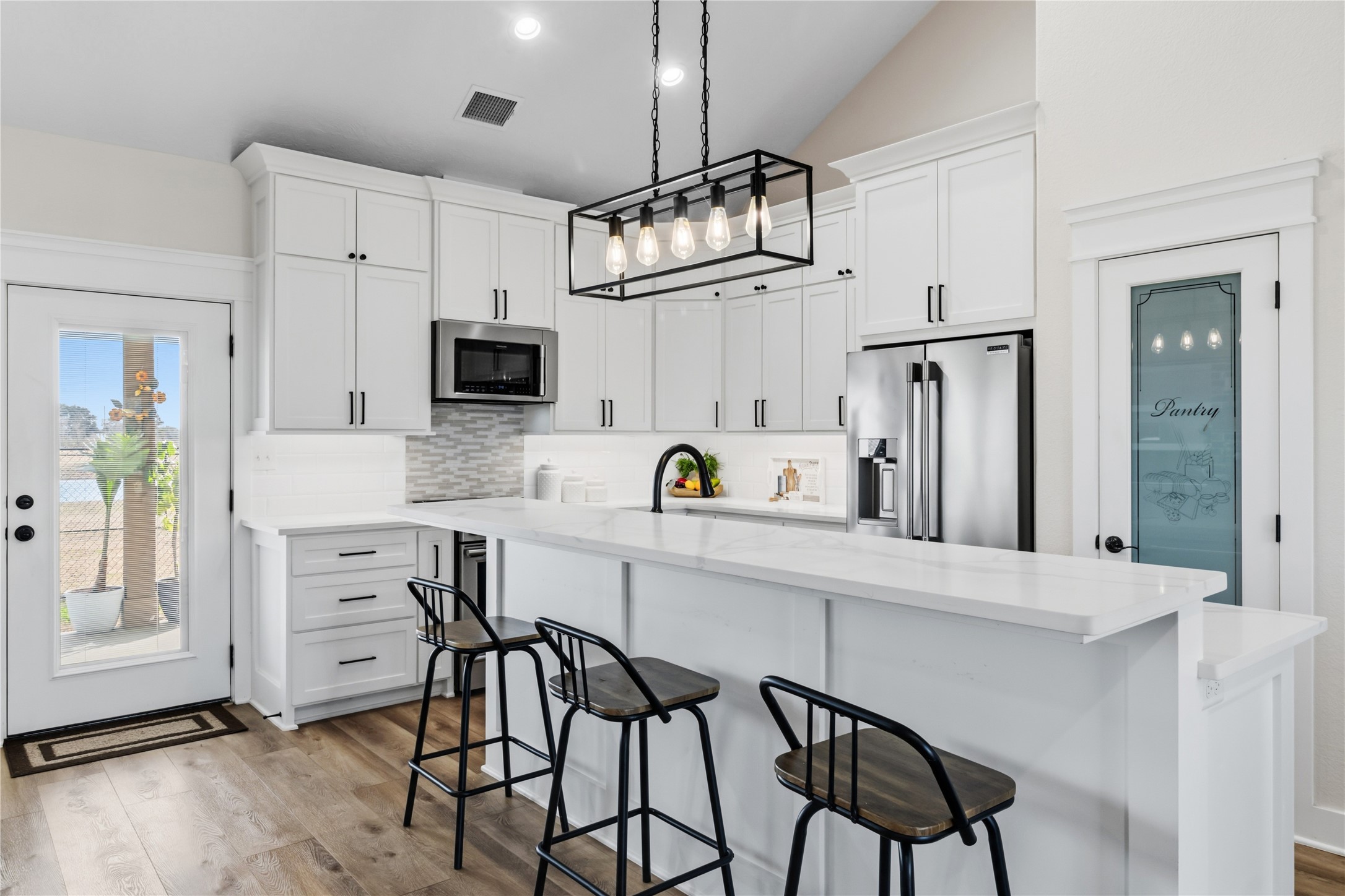 17637 Englin Road Winnie, TX 77665 - Photo 8 of 37 a kitchen with white cabinets and stainless steel appliances