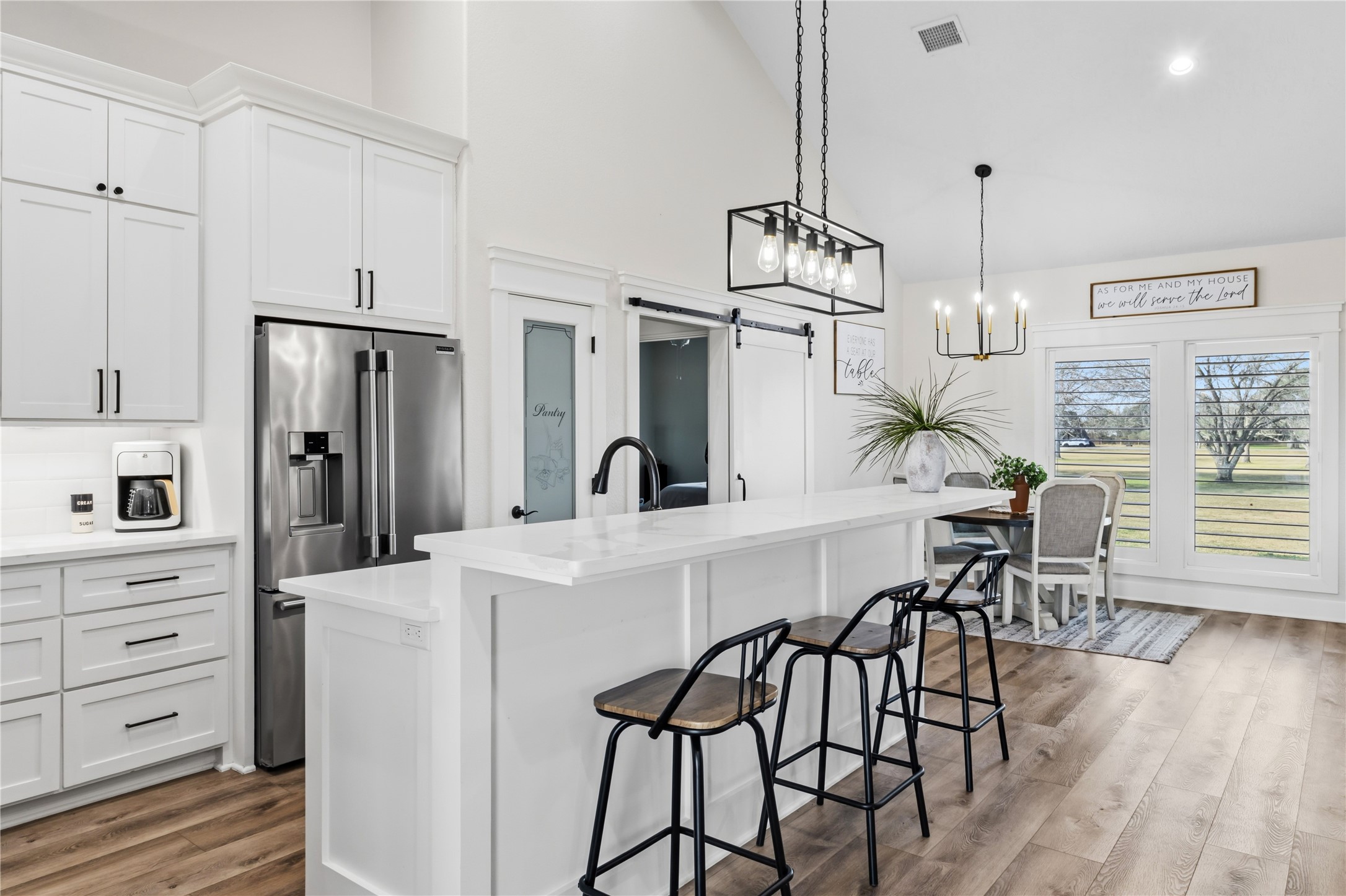 17637 Englin Road Winnie, TX 77665 - Photo 9 of 37 a kitchen with stainless steel appliances a dining table chairs refrigerator and sink