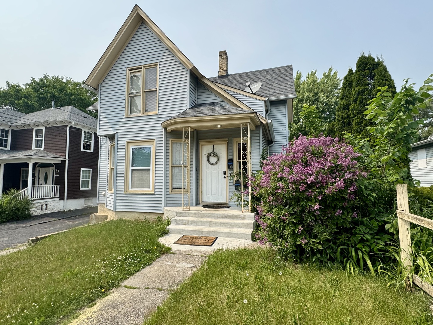 a front view of a house with a garden