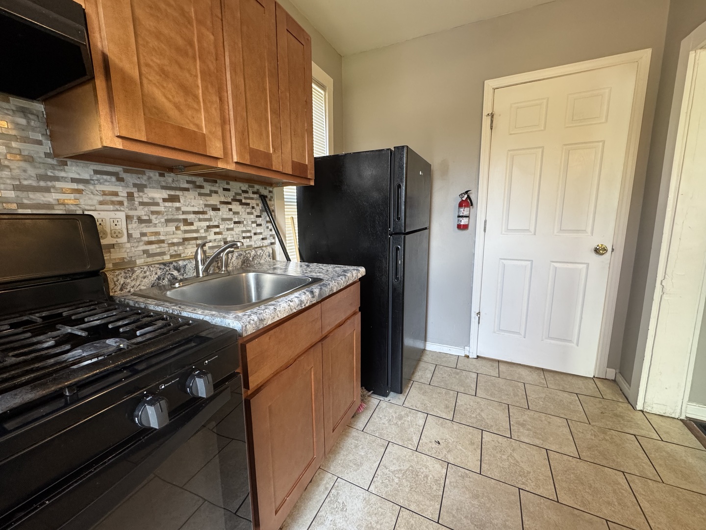 370 Bent Street, Unit 1 Elgin, IL 60120 - Photo 7 of 10 a kitchen with a stove and a refrigerator