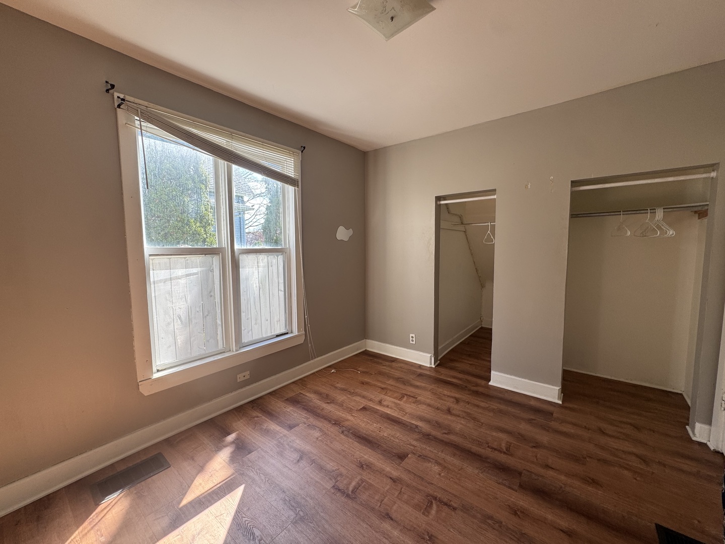 370 Bent Street, Unit 1 Elgin, IL 60120 - Photo 8 of 10 an empty room with wooden floor and windows