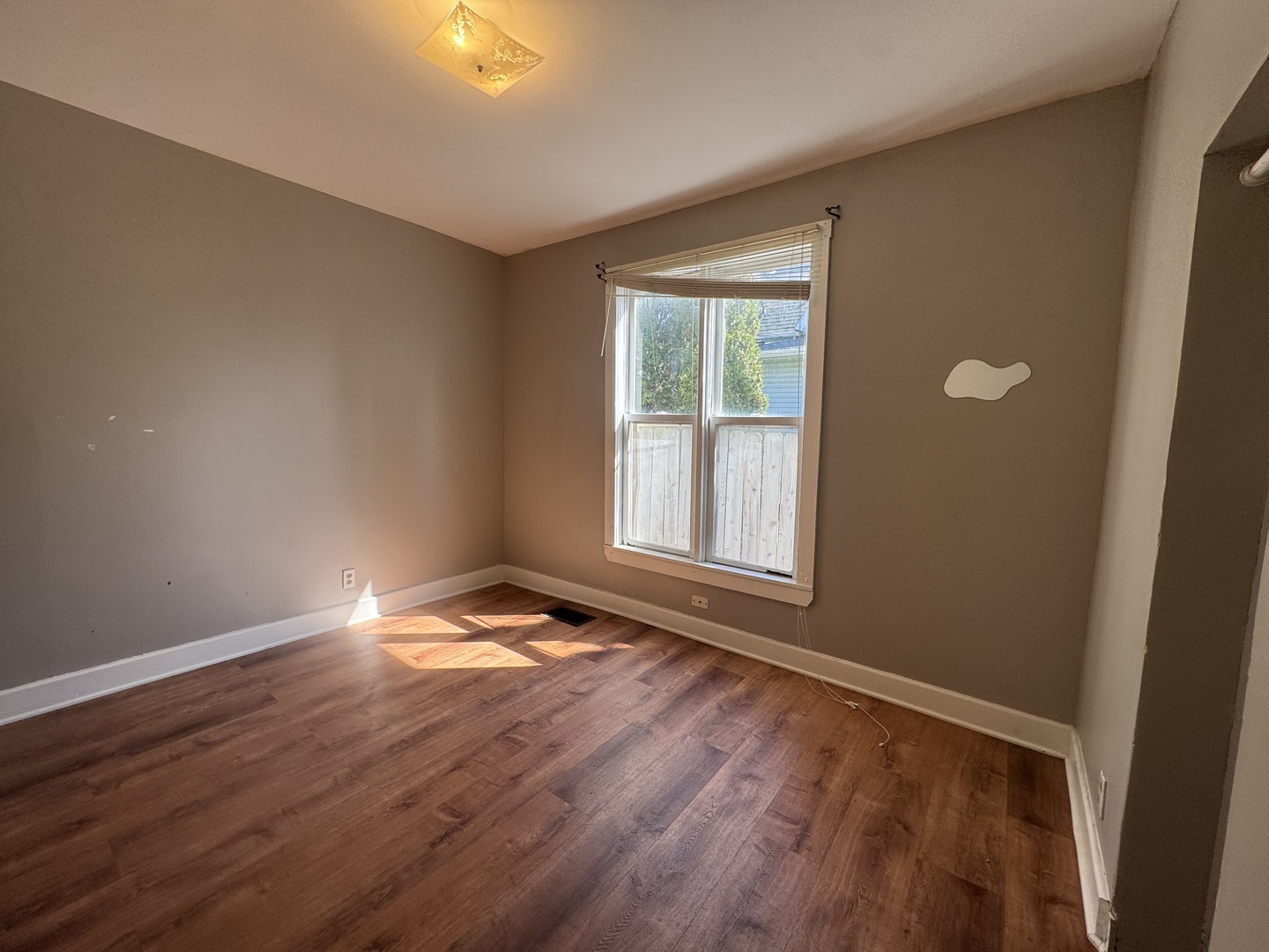 370 Bent Street, Unit 1 Elgin, IL 60120 - Photo 9 of 10 a view of an empty room with wooden floor and a window