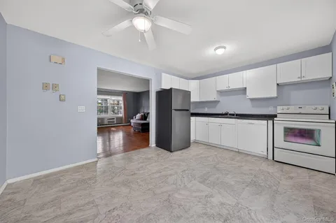 a kitchen with stainless steel appliances a refrigerator sink and stove
