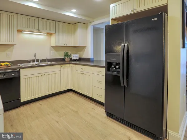 a kitchen with granite countertop white cabinets and appliances