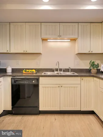 a kitchen with a table chairs and cabinets