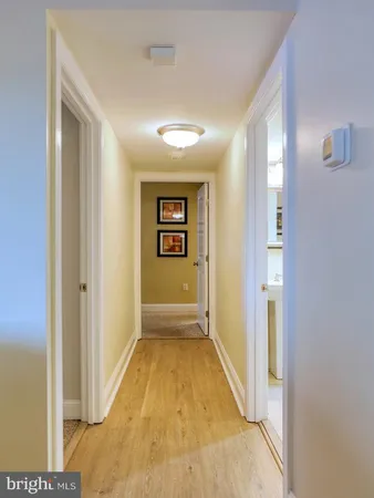 a bedroom with a bed and painting on the wall