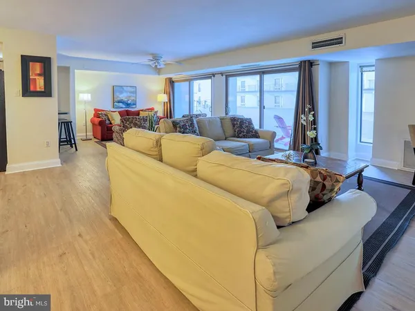 a living room with couches and a flat screen tv