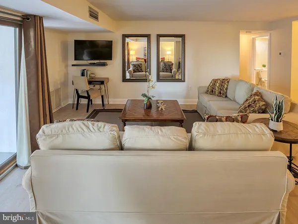 a view of a livingroom with furniture and a flat screen tv
