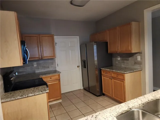 a view of a livingroom with wooden floor and a fireplace