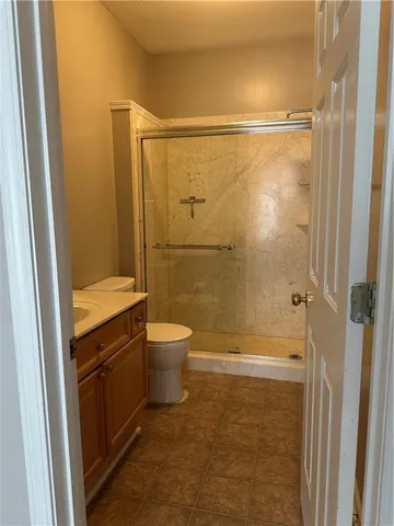 a bathroom with a granite countertop shower and a sink