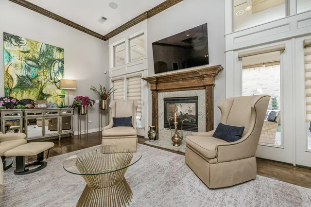 a living room with furniture a flat screen tv and a fireplace
