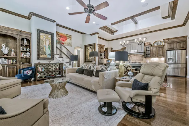 a living room with furniture and a ceiling fan
