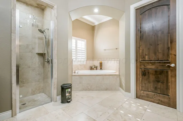 a bathroom with a tub shower and sink