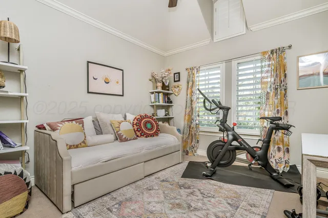 a living room with furniture a gym equipment and a large window