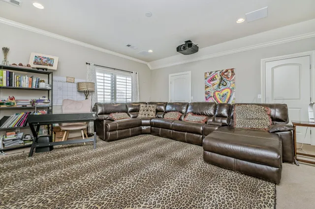 a living room with furniture a couch and a bookshelf