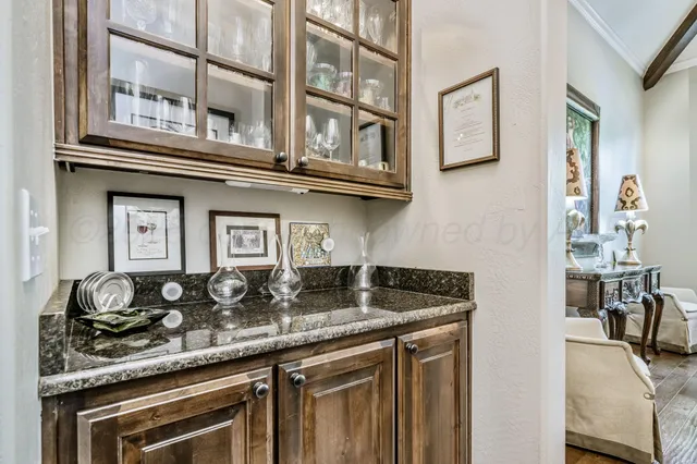 a kitchen with a granite countertop counter space a stove and cabinets