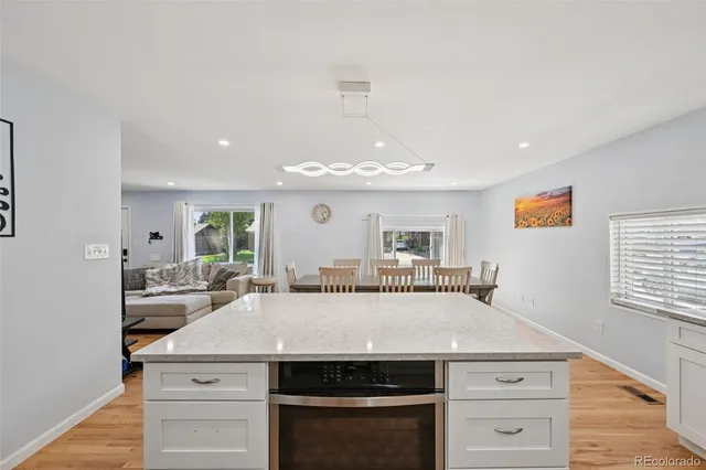 a kitchen with a stove and a chandelier