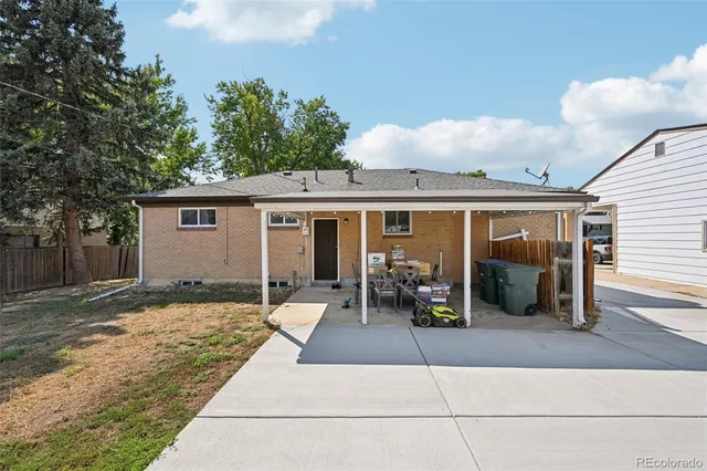 a front view of a house with a tree