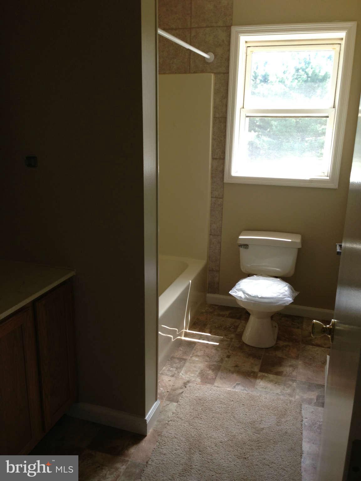 12129 Houck Road Union Bridge, MD 21791 - Photo 4 of 12 a bathroom with a toilet and a shower
