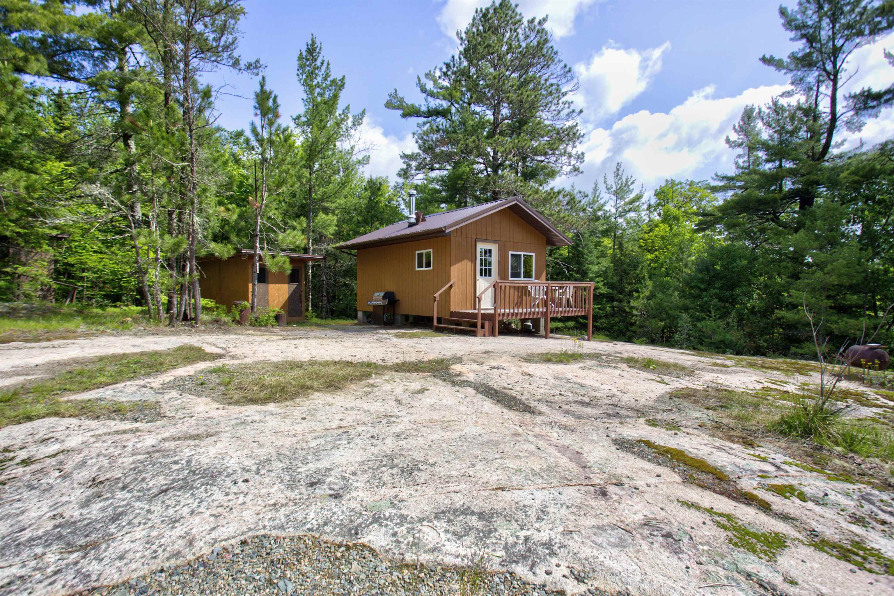 View of side of home featuring a wooden deck