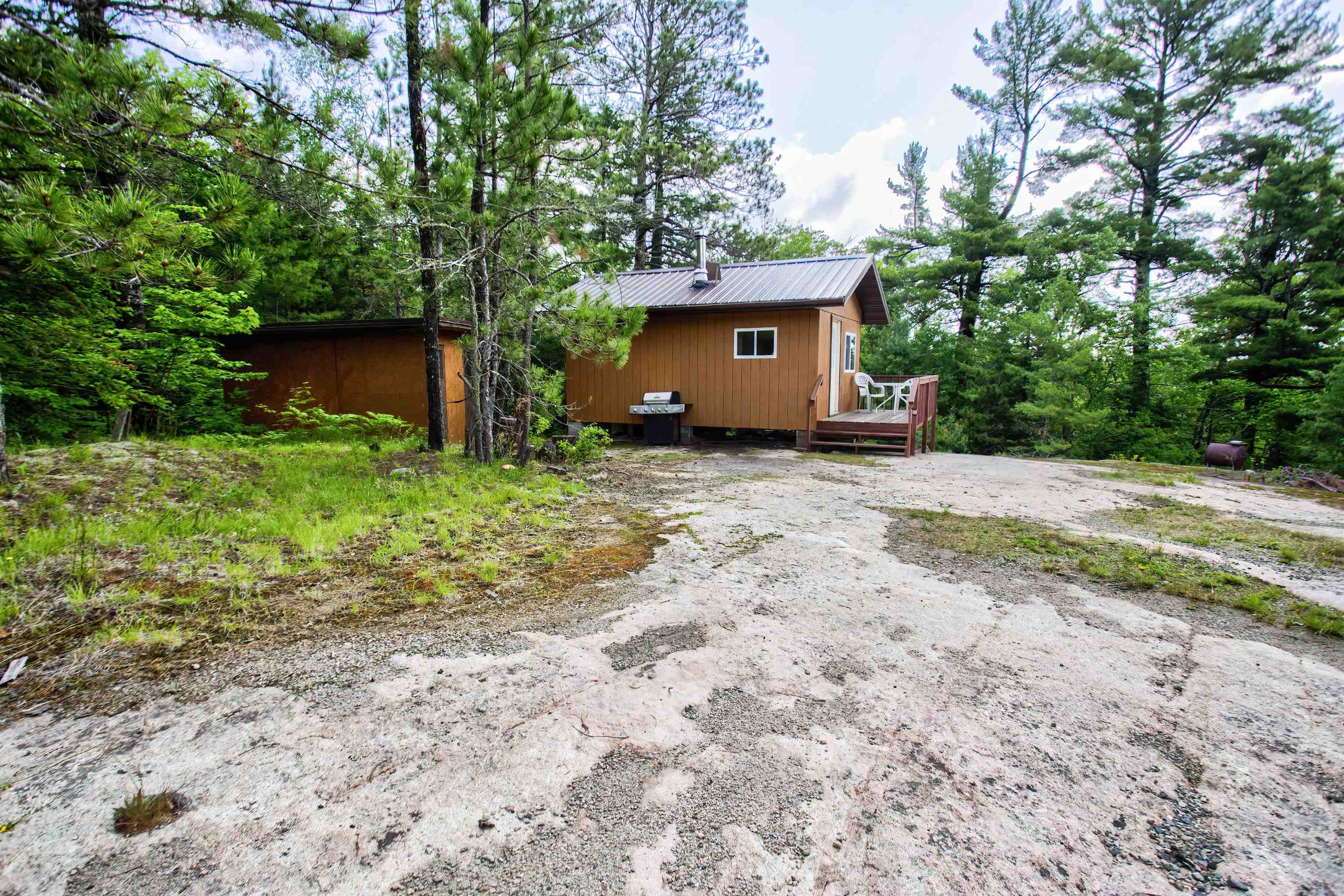 4194 Nels Lake Road Ely, MN 55731 - Photo 15 of 27 View of home's exterior featuring a deck and a metal roof