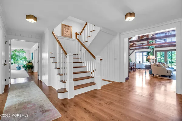 a view of entryway and hall with wooden floor