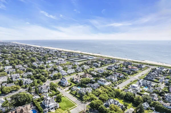 a living room with furniture a fireplace and a large window
