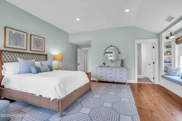 a front view of a house with a yard and green space