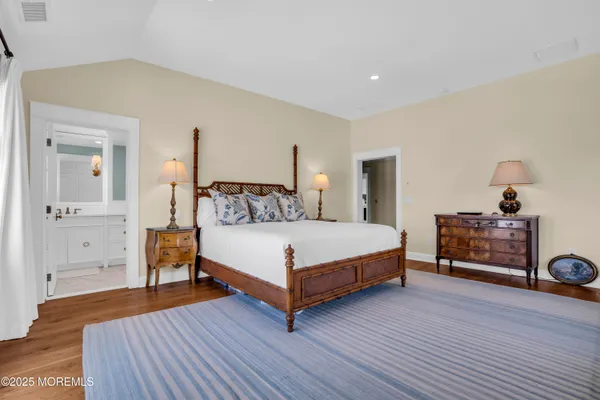 a bedroom with a bed lamp on table and a window