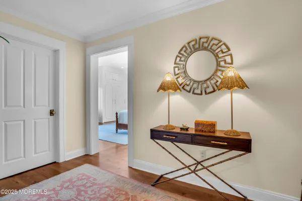 a view of entryway and hall with wooden floor
