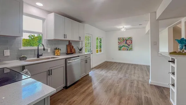 a kitchen with a refrigerator and a sink