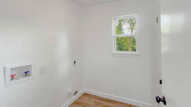 a view of a small space with window and closet