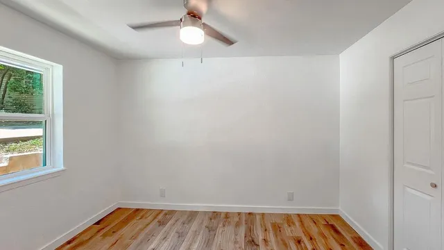 wooden floor in an empty room with a window