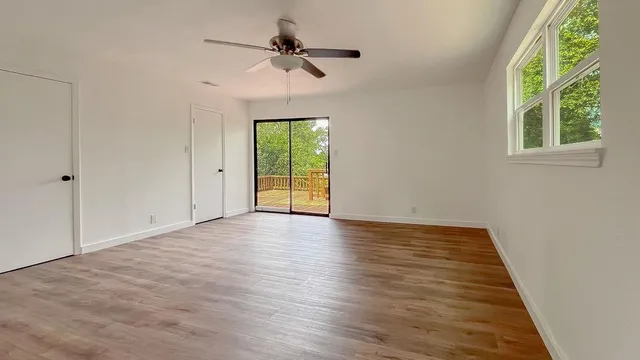 wooden floor in an empty room with a window