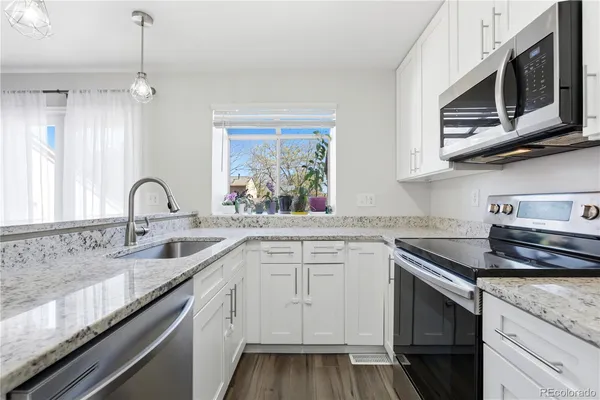 a kitchen with sink cabinets and window